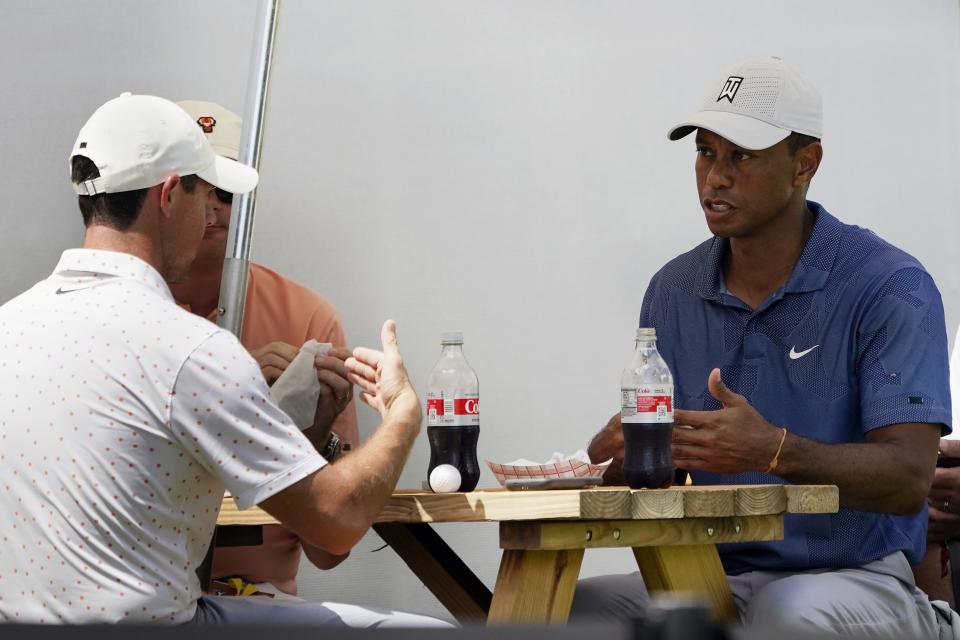 Tiger Woods, right, has lunch with Rory McIlory, left, during the third round of the Northern Trust golf tournament at TPC Boston, Saturday, Aug. 22, 2020, in Norton, Mass. (AP Photo/Charles Krupa)
