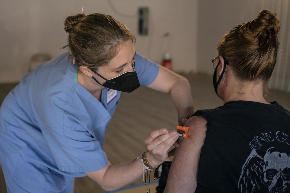 Nurse practitioner Tara Biller administers a COVID-19 vaccination during the Joints4Jabs COVID-19 vaccination clinic, hosted by Pliable, at the Uncle Ikes White Center cannabis shop on June 16, 2021 in Seattle, Washington. (David Ryder/Getty Images)