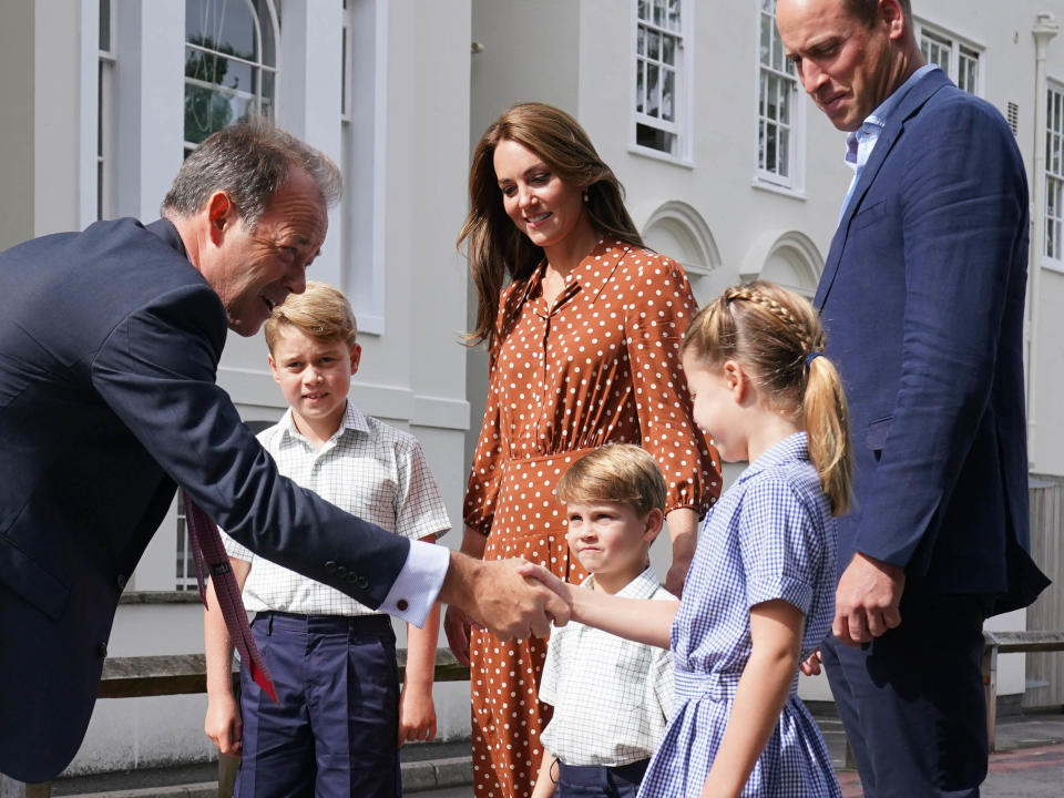 Prince George, Princess Charlotte and Prince Louis greet the headmaster at their new school in September 2022.  (Getty Images)