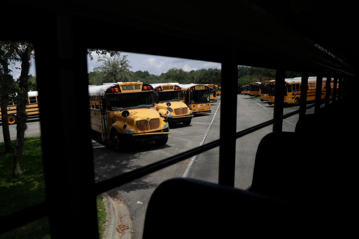 Busses wait for drivers at the Conner-Lakes Leon County Schools Bus Compound Tuesday, August 13, 2019. 