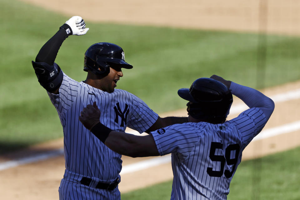 New York Yankees' Aaron Hicks celebrates with Luke Voit (59) after hitting a two-run home run against the New York Mets during the seventh inning of the first baseball game of a doubleheader, Sunday, Aug. 30, 2020, in New York. (AP Photo/Adam Hunger)