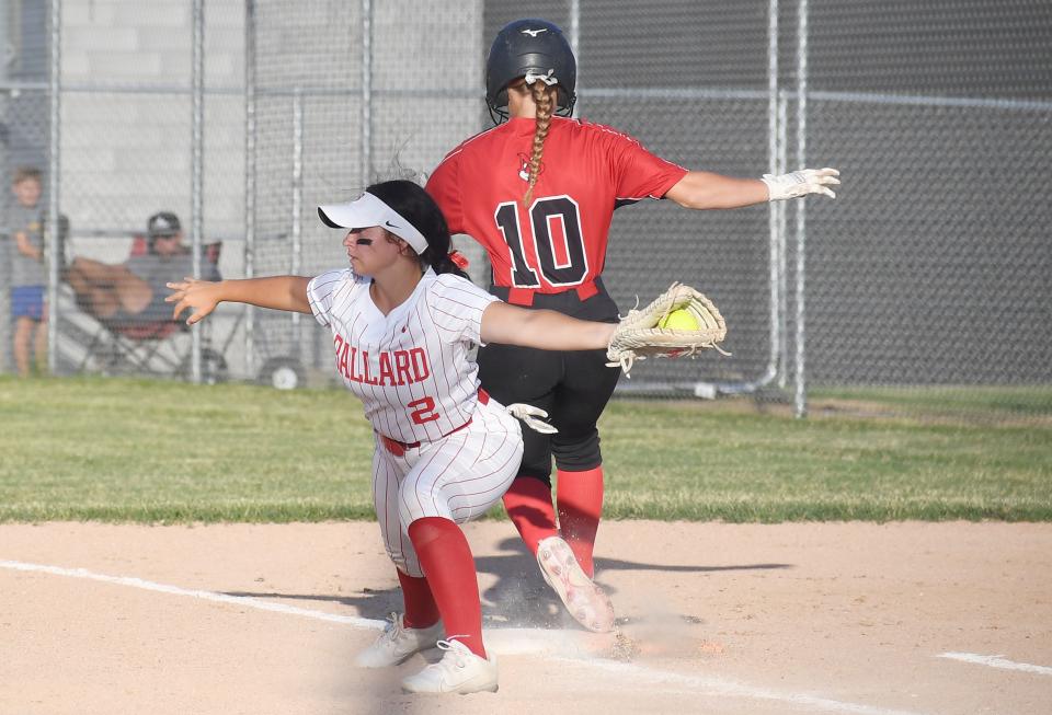 Ballard first baseman Kora Johnson (2) catches the ball as North Polk's Katelyn Klever (10) reaches first base during the second inning of the Bombers' 3-2 loss to the Comets at Gary Telford Field Tuesday, June 28, 2022, in Huxley, Iowa.