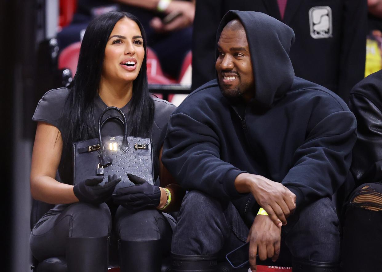 Kanye West and girlfriend Chaney Jones attend a game between the Miami Heat and the Minnesota Timberwolves at FTX Arena on March 12, 2022 in Miami, Florida. NOTE TO USER: User expressly acknowledges and agrees that, by downloading and or using this photograph, User is consenting to the terms and conditions of the Getty Images License Agreement