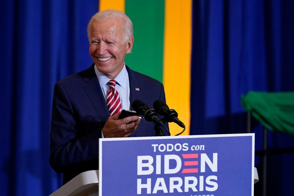 Democratic presidential candidate former Vice President Joe Biden plays music on a phone as he arrives to speak at a Hispanic Heritage Month event, Sept. 15, 2020, at Osceola Heritage Park in Kissimmee, Fla.