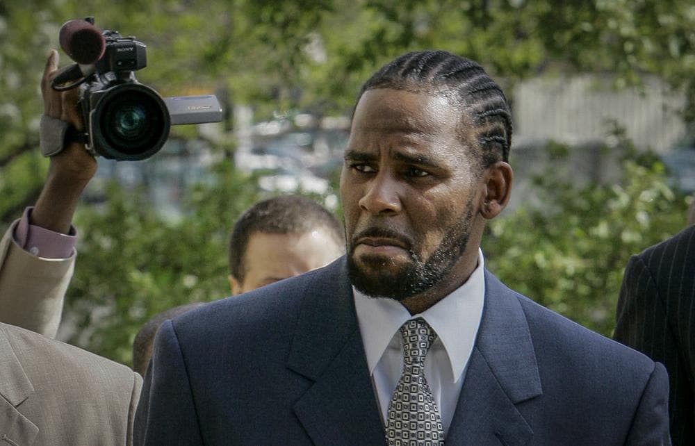 This photo from Friday May 9, 2008, shows R. Kelly arriving for the first day of jury selection in his child pornography trial at the Cook County Criminal Courthouse in Chicago. (AP Photo/Charles Rex Arbogast, File)