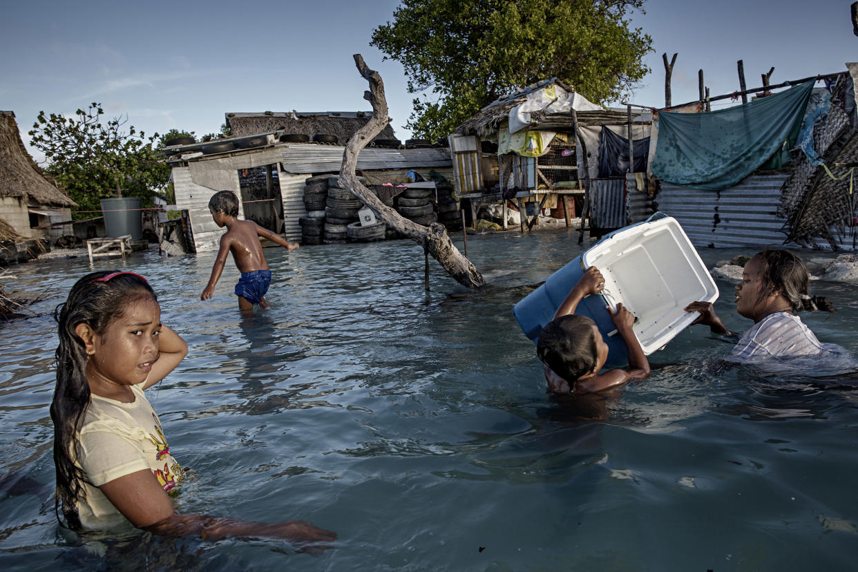 Image: Large parts of the village Eita has drowned in flooding from the sea, Kiribati. (Jonas Gratzer / LightRocket via Getty Images file)