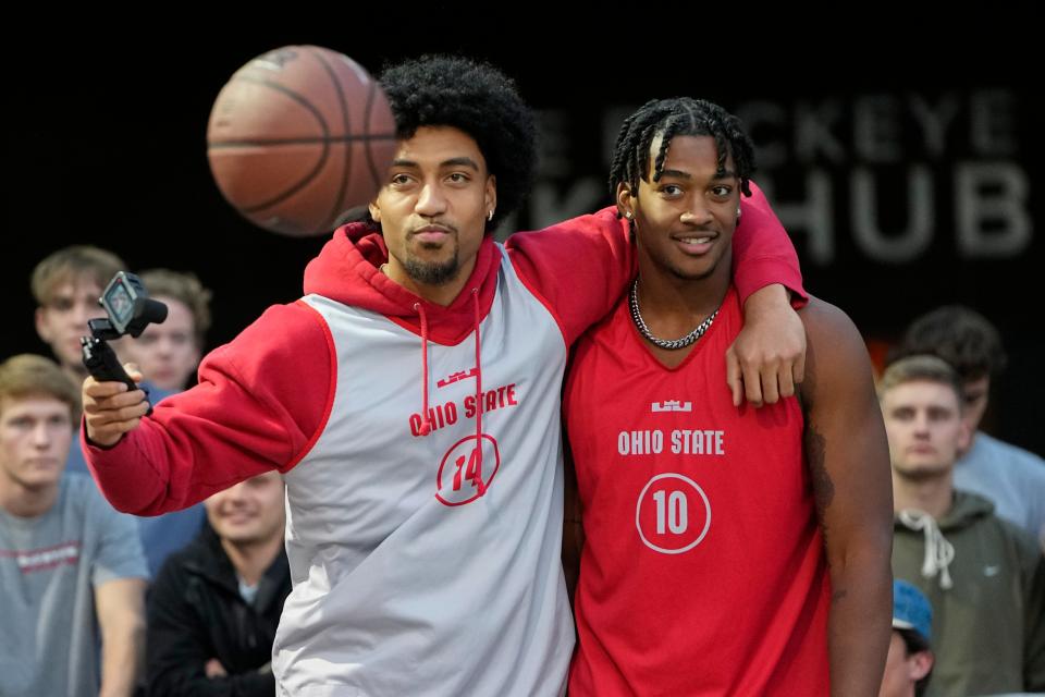 Oct 6, 2022; Columbus, OH, USA;  Ohio State men's basketball forward Justice Sueing (14) and forward Brice Sensabaugh (10) take a video during the “Buckeyes on the Blacktop” event on the rec basketball courts behind Ohio Stadium. Mandatory Credit: Adam Cairns-The Columbus Dispatch