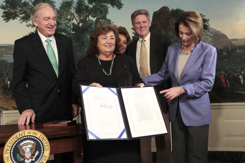 Jeanne White-Ginder, Ryan White's mother, holds the Ryan White HIV/AIDS Treatment Extension Act of 2009 after it was signed by President Barack Obama in the Diplomatic Reception Room of the White House on October 30, 2009. File Photo by Aude Guerrucci/UPI