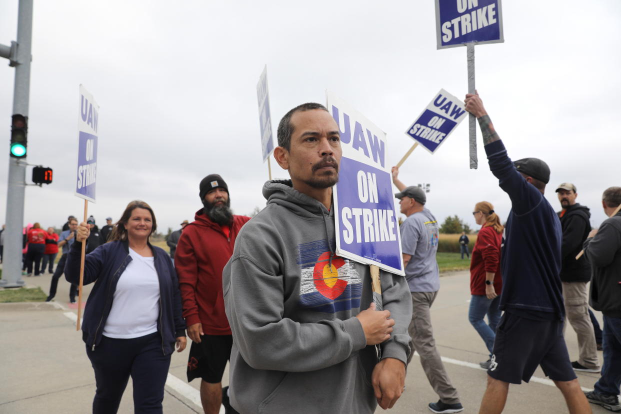 Striking members of the United Auto Workers (UAW), including Mark Allen of Des Moines, picket at the Deere & Co farm equipment plant before a visit by U.S. Agriculture Secretary Tom Vilsack in Ankeny, Iowa, U.S. October 20, 2021. REUTERS/Scott Morgan