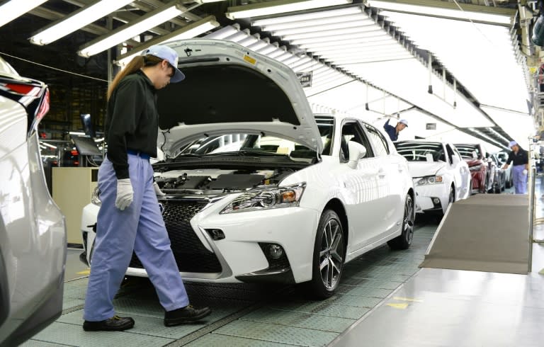 Employees of Toyota Motor's subsidiary Toyota Motor Kyushu check Lexus vehicles on an assembly line at the Miyata Plant in Miyawaka, Fukuoka prefecture