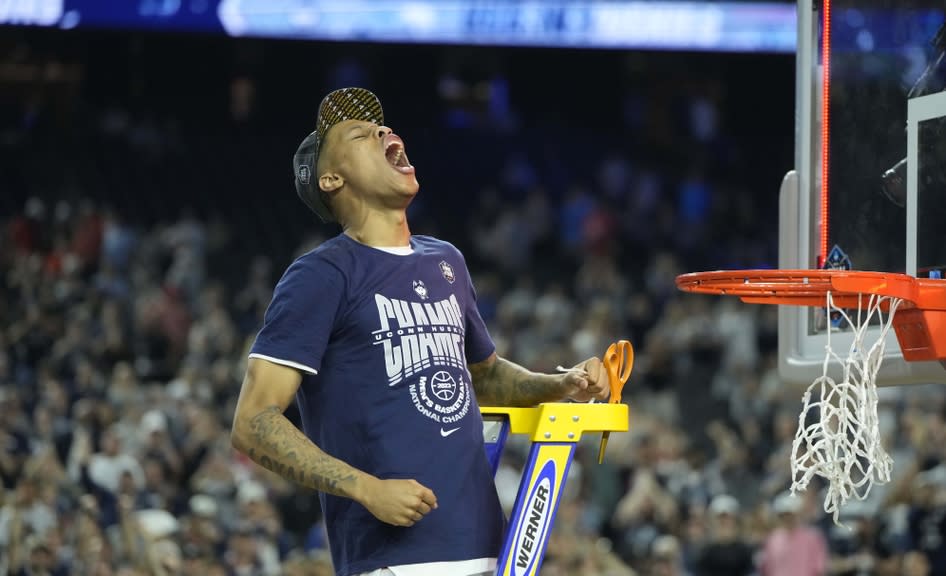 Connecticut Huskies guard Jordan Hawkins (24) celebrates with cutting the net after defeating the San Diego State Aztecs in the national championship game of the 2023 NCAA Tournament at NRG Stadium.