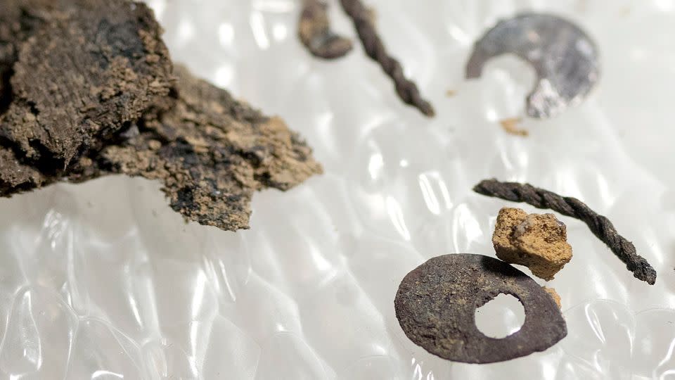 Es werden Stoffe und Pailletten vorgestellt, die bei der Ausgrabung der Bestattungen entdeckt wurden – Jamestown Rediscovery Foundation (Preservation Virginia)