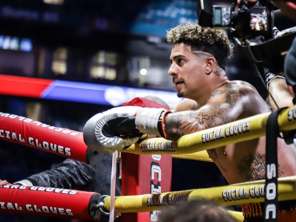 YouTube creator Austin McBroom leans over the ring after a boxing match at the Hard Rock Stadium in Miami on June 12, 2021