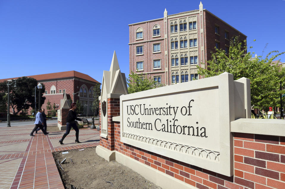 FILE - This March 12, 2019 file photo shows the University Village area of the University of Southern California in Los Angeles. The past year has been a bruising one for the Los Angeles university. The president who helped boost the school's endowment above $6 billion had to step down amid investigations into a medical school dean accused of smoking methamphetamine with a prostitute who overdosed, its longtime gynecologist was accused of sexual misconduct by hundreds of women he examined over decades and an assistant men's basketball coach pleaded guilty to charges stemming from an FBI probe of corruption in college basketball. (AP Photo/Reed Saxon,File)