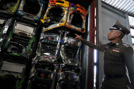 Deputy police chief Pol Gen Wirachai Songmetta, inspects blocks of electronic waste hidden in a freight container during a search at Leam Chabang industrial estate, Chonburi province, Thailand, May 29, 2018. REUTERS/Athit Perawongmetha