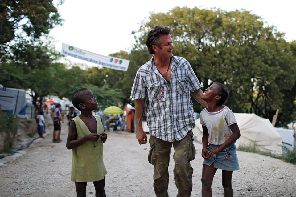 Penn pals around with local children on the grounds of the refugee camp he helped build on the Petionville golf club in the outskirts of Portau-Prince, Haiti, in November 2010. - Credit: Corentin Fohlen/Abcapress.com/Alamy