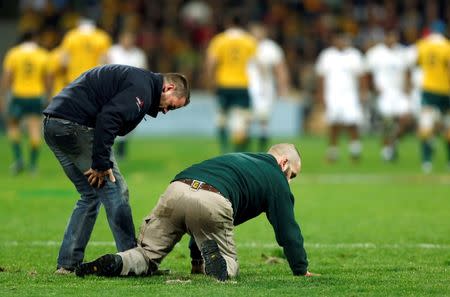 Rugby Union - Rugby Test - England v Australia's Wallabies - Melbourne, Australia - 18/06/16. Officials attempt to repair turf during the first half of the match between Australia and England. REUTERS/Brandon Malone