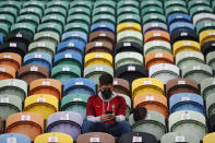 A young man wearing a face mask takes a seat marked as available to watch a soccer match between Portugal and Sweden at the Jose Alvalade stadium in Lisbon, Portugal, Wednesday, Oct. 14, 2020. Five thousand spectators were allowed on the stands but starting Wednesday at midnight, and for the upcoming two weeks, a maximum of five people will be allowed together either indoors or outdoors in public spaces and establishments such as restaurants due to a steady increase in cases of COVID-19 in the past weeks. (AP Photo/Armando Franca)