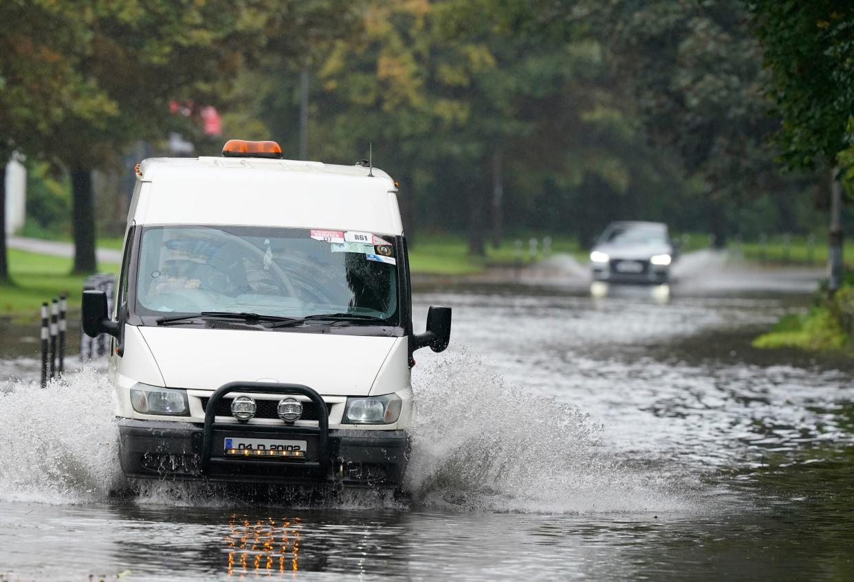 A van driving through floodwater in Cork (PA)