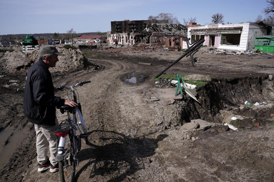 TROSTIANETS, UKRAINE - APRIL 15, 2022 - A man standing by his bicycle observes the destruction caused by the shelling of Russian troops as seen in the city liberated from Russian invaders, Trostianets, Sumy Region, northeastern Ukraine. (Photo by Anna Voitenko/Ukrinform/NurPhoto via Getty Images)