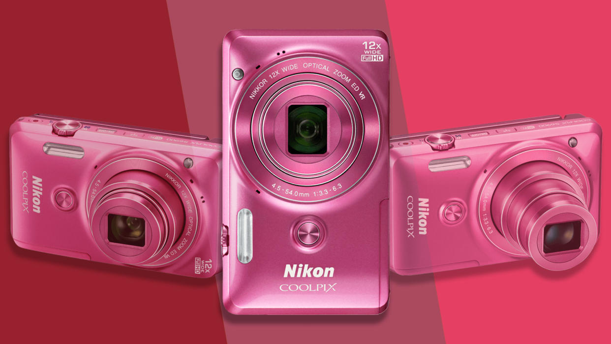  Pink Nikon Coolpix S6900 camera on a pink background. 