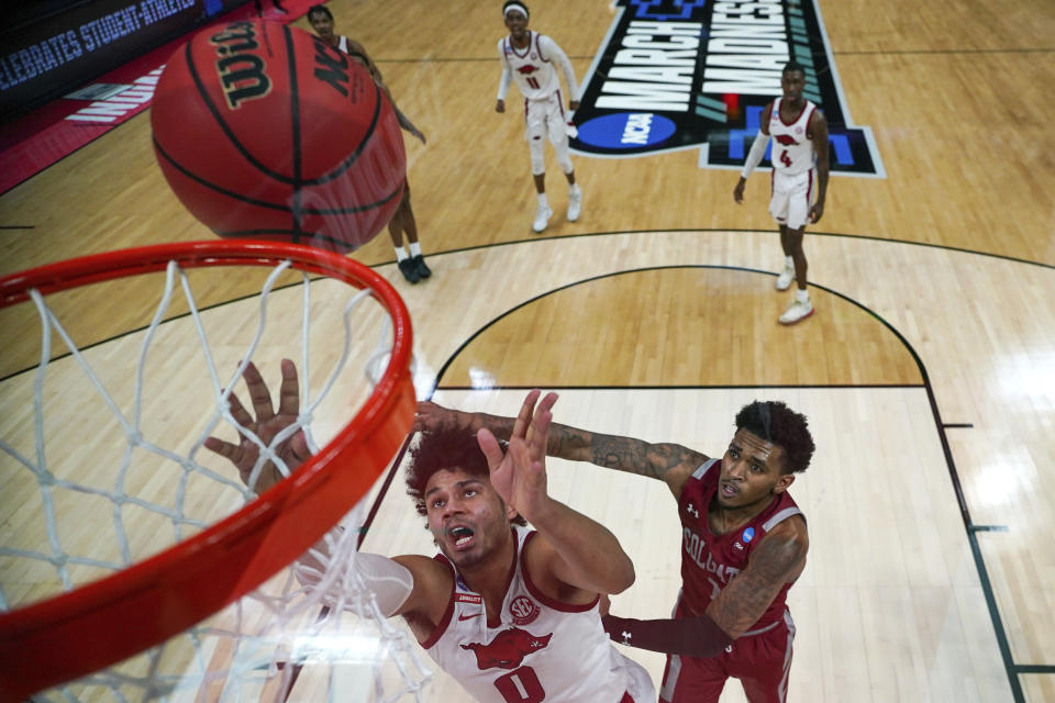 Arkansas' Justin Smith (0) fights for a rebound with Colgate's Jordan Burns, right, during a first-round men's college basketball game in the NCAA Tournament, Friday, March 19, 2021, at Bankers Life Fieldhouse in Indianapolis. (Jack Dempsey/Pool Photo via AP)