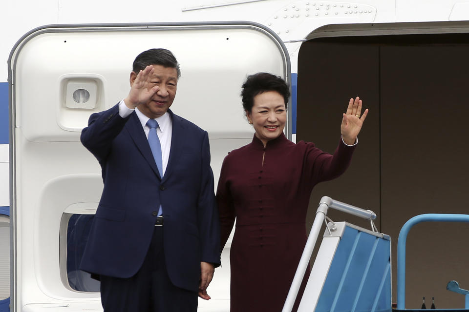 Chinese President Xi Jinping, left, and his wife Peng Liyuan, right, wave as they arrive at Noi Bai International airport in Hanoi, Vietnam, Tuesday, Dec. 12, 2023. Chinese leader Xi arrived in Vietnam on Tuesday seeking to further deepen ties with the Southeast Asian nation, weeks after it elevated its diplomatic relations with Western-aligned countries. (Luong Thai Linh/Pool Photo via AP)