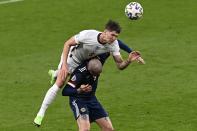 England's John Stones, top, and Scotland's Lyndon Dykes jump for the ball during the Euro 2020 soccer championship group D match between England and Scotland, at Wembley stadium, in London, Friday, June 18, 2021. (Facundo Arrizabalaga/Pool via AP)