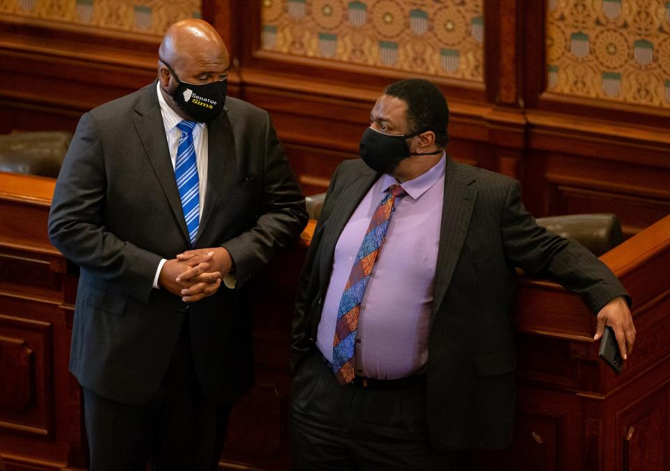 Illinois state senator Elgie R. Sims, Jr., D-Chicago, left talks with Illinois state senator Emil Jones III, D-Chicago, right, on the floor of the Illinois senate in this 2020 photo. Sims has been a leading advocate for criminal justice reform in Illinois.