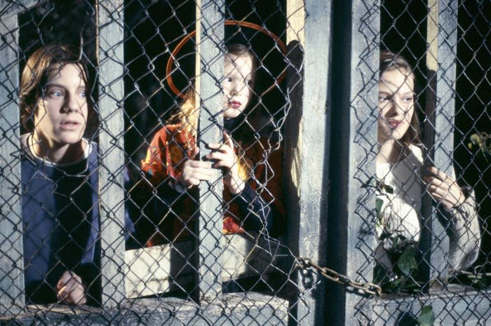 Omri, with two others, looking through a chainlink fence in a scene from Hocus Pocus