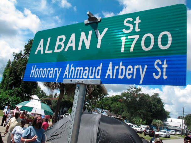PHOTO: A crowd gathers under a new sign designating a city roadway as Honorary Ahmaud Arbery Street, Aug. 9, 2022, in Brunswick, Ga. (Russ Bynum/AP)