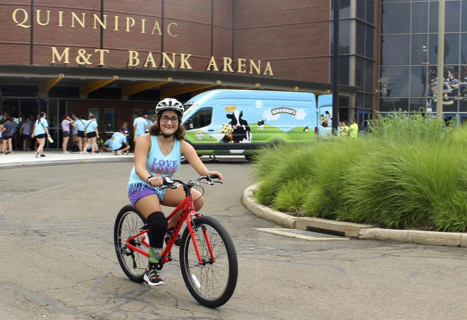 Mariam Keep, 12, of North Wales, Penn., rides a bike during Camp No Limits at Quinnipiac University, Friday, July 14, 2023 in Hamden, Conn. Rhodes, was born with congenital limb difference. Camp No Limits is helping train students at Quinnipiac University with a four-day program, run and staffed by students in the university's physical and occupational therapy program on the school's campus. (AP Photo/Pat Eaton-Robb)