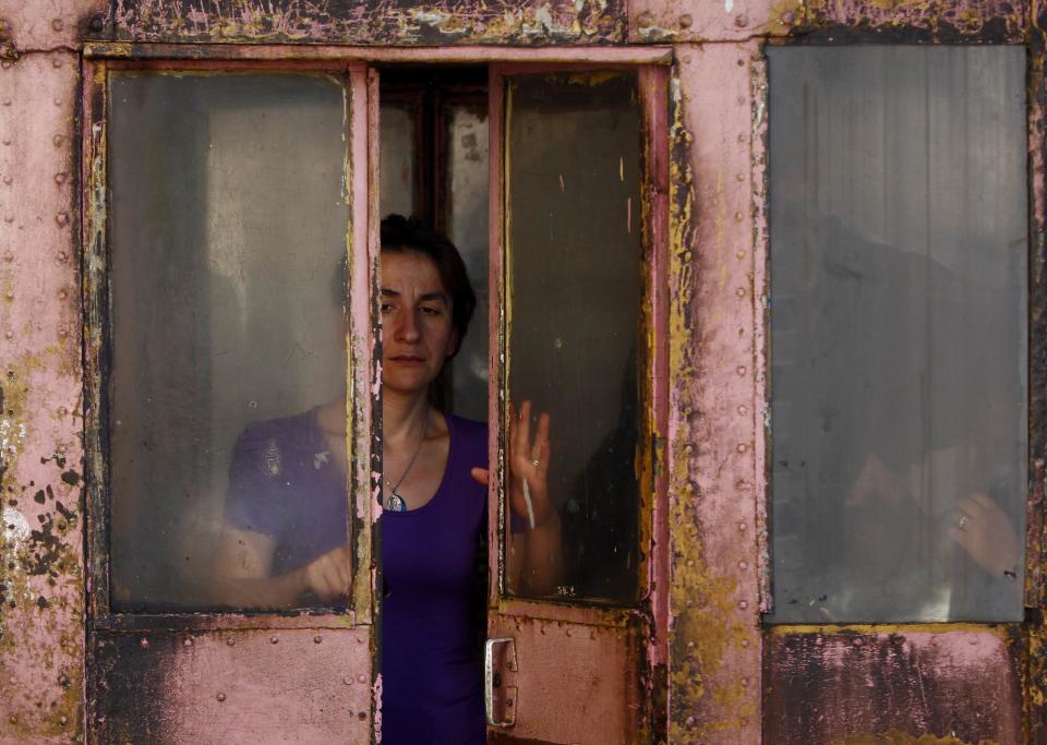 A conductor closes the doors of a 60-year-old cable car before its departure in the town of Chiatura