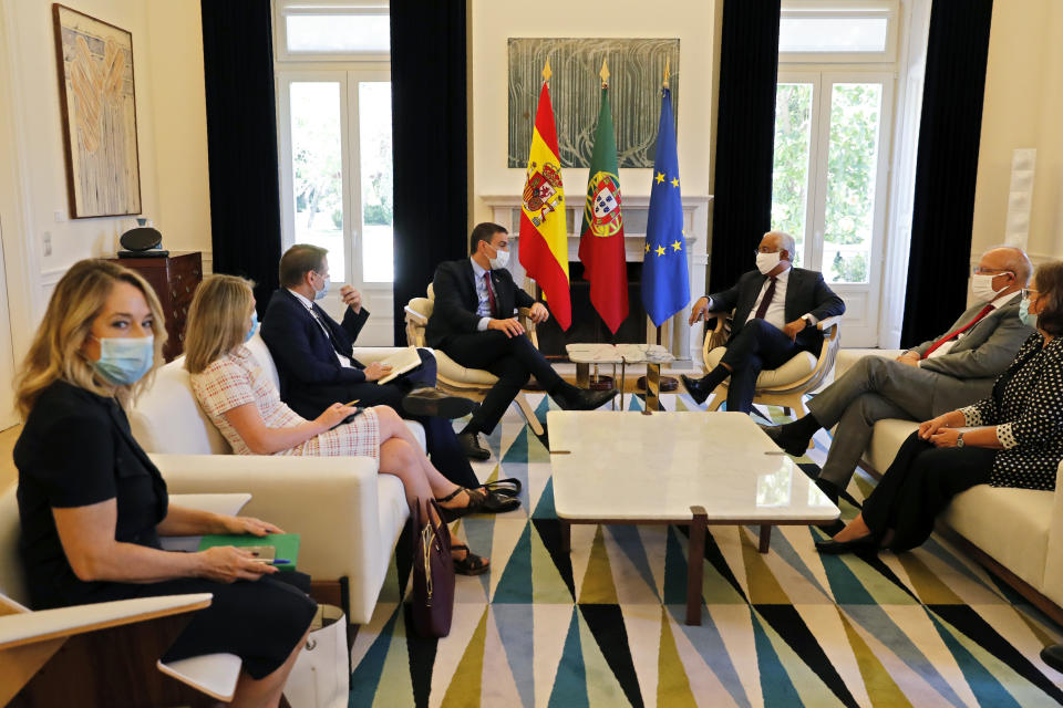 Spain's Prime Minister Pedro Sanchez, center left, is received by Portugal's Prime Minister Antonio Costa at the Sao Bento palace in Lisbon, Monday, July 6, 2020. (AP Photo/Armando Franca)