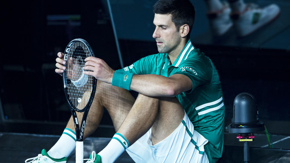 Novak Djokovic, pictured here sitting at the back of the court between games.