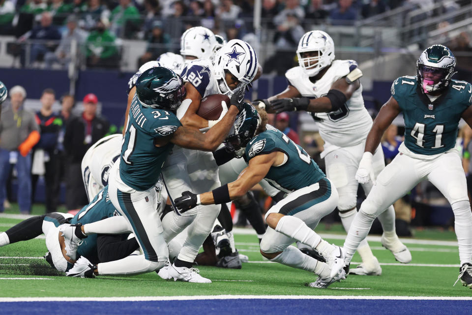 Dec 10, 2023; Arlington, Texas, USA; Dallas Cowboys running back Tony Pollard (20) is gang tackled by the Philadelphia Eagles in the second quarter at AT&T Stadium. Mandatory Credit: Tim Heitman-USA TODAY Sports