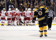 Boston Bruins' Patrice Bergeron skates off the ice as the Detroit Red Wings celebrate their 1-0 win in Game 1 of a first-round NHL playoff hockey series, in Boston on Friday, April 18, 2014. (AP Photo/Winslow Townson)