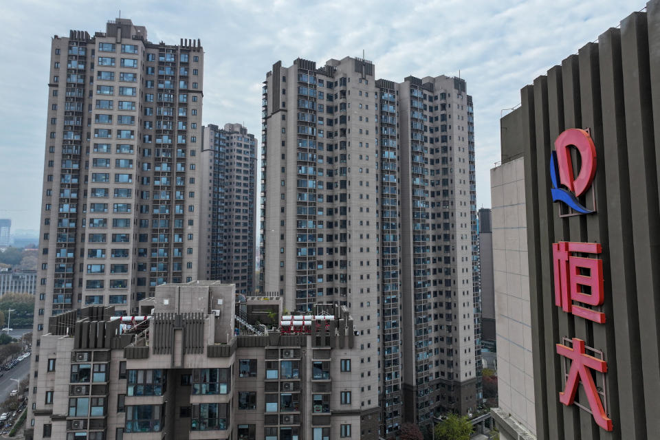 This aerial photo shows the Evergrande logo on residential buildings in Nanjing, in China's eastern Jiangsu province on December 4, 2023. Heavily indebted Chinese property giant Evergrande has until late January to put together a restructuring plan, a Hong Kong court ruled on December 4, extending a deadline that could lead to its liquidation. (Photo by AFP) / China OUT (Photo by STR/AFP via Getty Images)