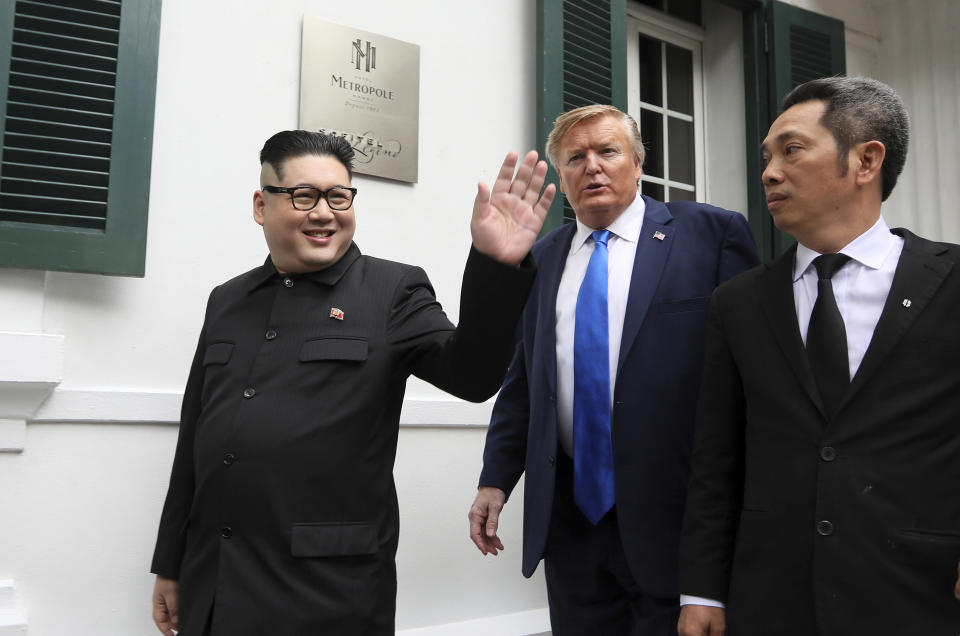 U.S. President Donald Trump impersonator Russell White, center, and North Korean leader Kim Jong-un impersonator Howard X pose for photos outside the Opera House in Hanoi, Vietnam, Friday, Feb. 22, 2019. The second summit between Trump and Kim will take place in Hanoi on Feb. 27 and 28. (AP Photo/Minh Hoang)