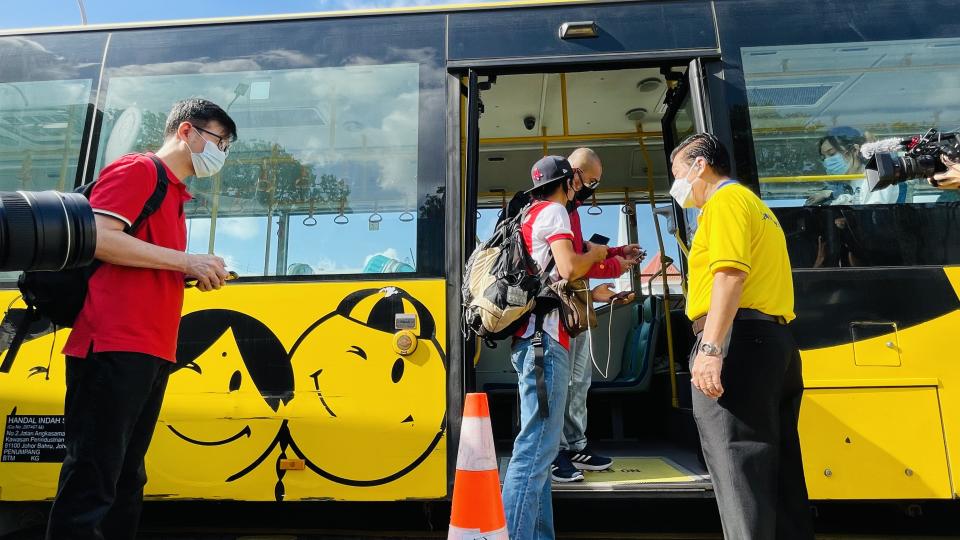 Travellers headed to Malaysia under the new land VTL scheme seen boarding their bus at the Queen Street bus terminal on Monday (29 November). (PHOTO: Dhany Osman / Yahoo News Singapore)