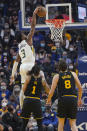 Utah Jazz guard Trent Forrest (3) dunks over Golden State Warriors guard Damion Lee (1) and forward Nemanja Bjelica (8) during the first half of an NBA basketball game in San Francisco, Sunday, Jan. 23, 2022. (AP Photo/Jeff Chiu)