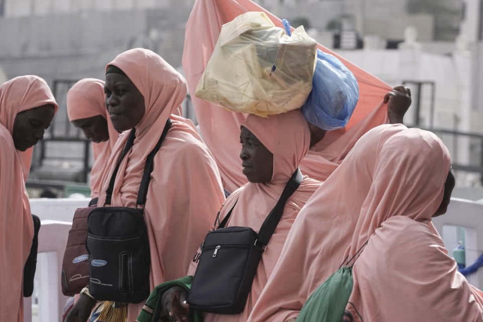 Nigerian pilgrims carry bags outside the Grand Mosque during the annual Hajj pilgrimage in Mecca, Saudi Arabia, Saturday, June 24, 2023. Straw hats, cross-body bags, and collapsible chairs are some essentials pilgrims have on them as they perform the Hajj. The fifth pillar of Islam is a profoundly spiritual experience but requires practical and specific preparation to deal with hours of walking in scorching temperatures, camping stints, and massive crowds. (AP Photo/Amr Nabil)