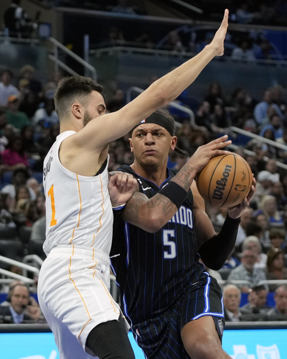 Orlando Magic's Paolo Banchero (5) goes to the basket against Miami Heat's Max Strus during the second half of an NBA basketball game, Saturday, Feb. 11, 2023, in Orlando, Fla. (AP Photo/John Raoux)