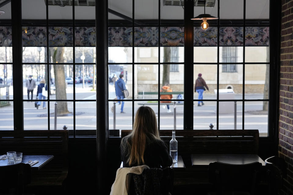 A customer sits in a restaurant, in Paris, Monday, Jan. 24, 2022. Unvaccinated people are no longer allowed in France's restaurants, bars, tourist sites and sports venues. A new law came into effect Monday requiring a "vaccine pass" that is central to the government's anti-virus strategy. (AP Photo/Thibault Camus)