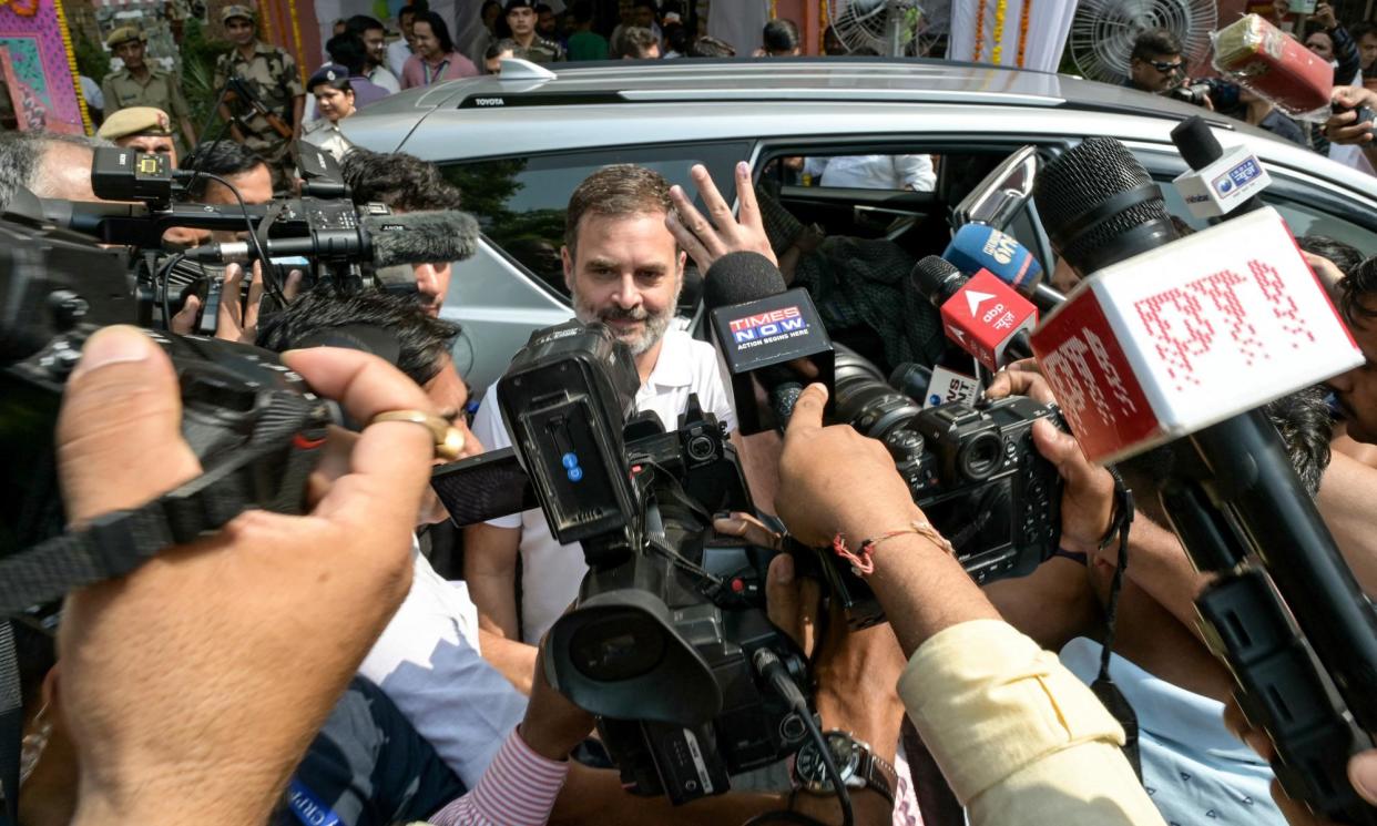 <span>Indian National Congress (INC) party candidate Rahul Gandhi (C) shows his inked finger after casting his ballot at a polling station in New Delhi on 25 May.</span><span>Photograph: Arun Sankar/AFP/Getty Images</span>