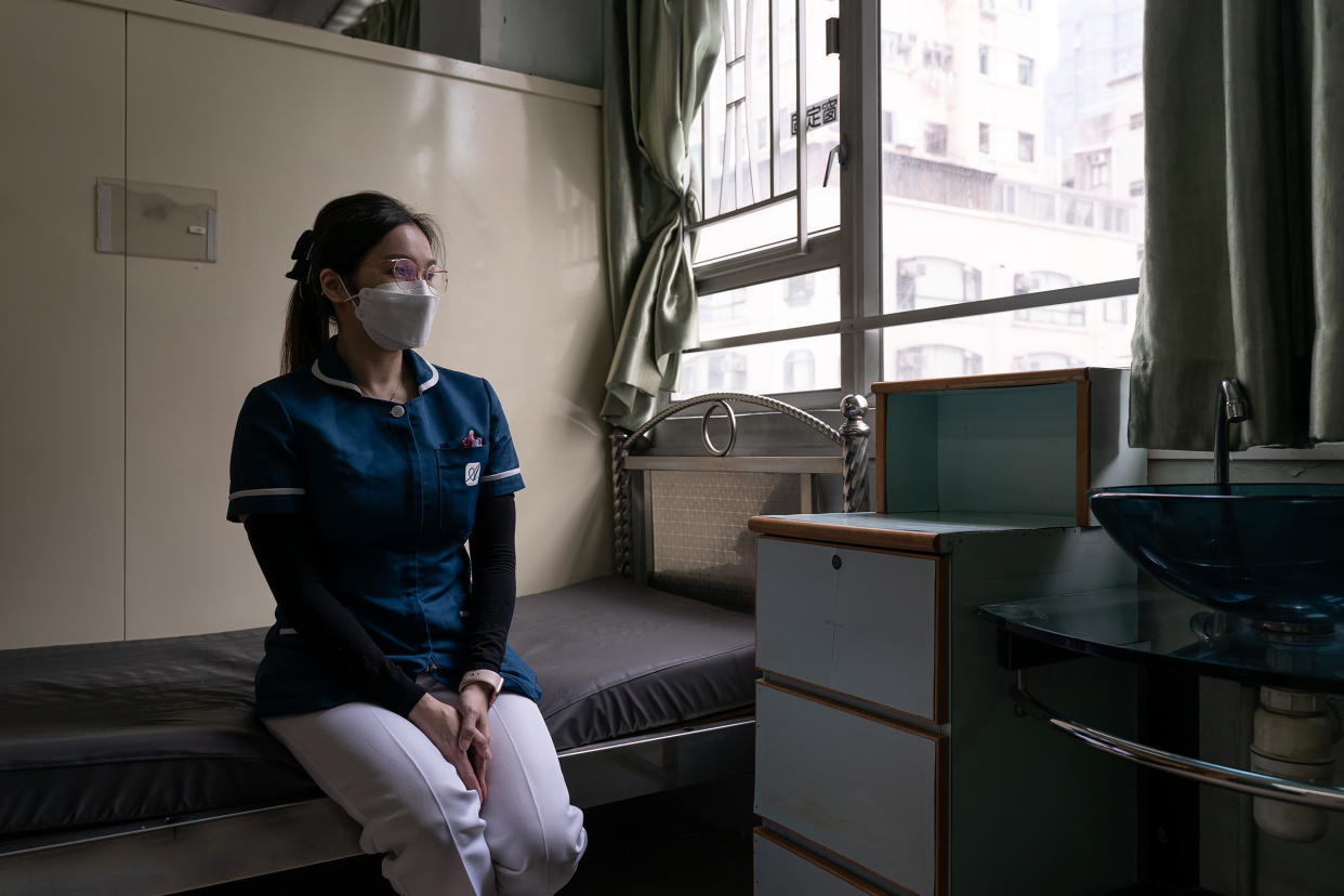 Wong Wing-yan, a nurse at Kei Tak (Tai Hang) Home For the Aged, sits in her godmother’s living cubicle, who has recently passed away due to the fifth wave of pandemic, in Yuen Long district in Hong Kong on May 6, 2022.