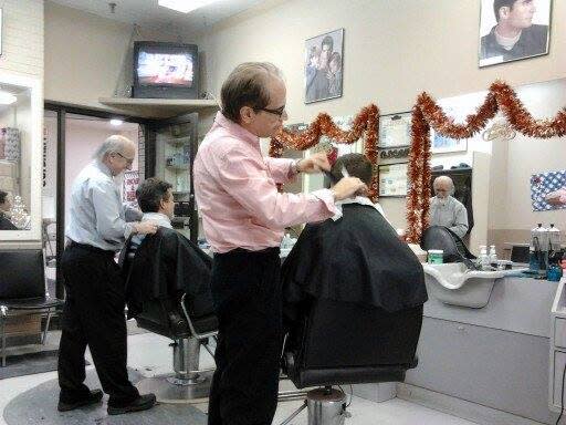 Oscar Orazietti and Dario Siciliano, former owners of Oscar and Dario Unisex Hairstyling and Barbering, work in the shop shortly after giving the keys over to Monic and John Cvengros in 2013-14. Siciliano continued to work at the shop for several years after this change of ownership took place.