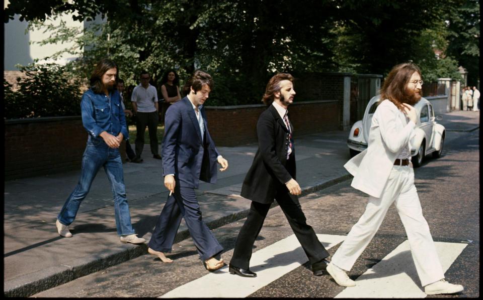 The Beatles walk across the zebra crossing outside Abbey Road Studios - MPL