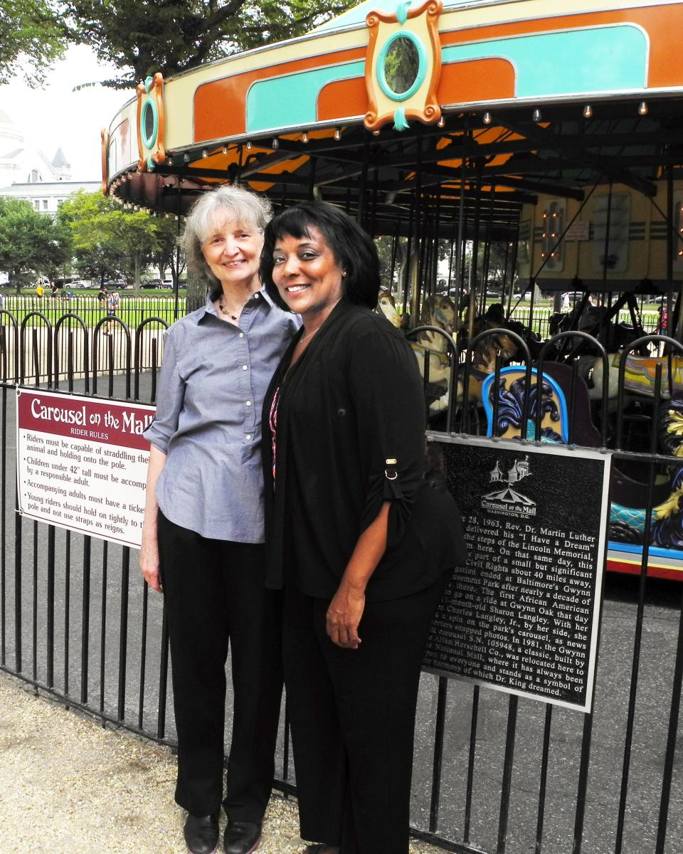 Author Amy Nathan, left, with Sharon Langley at the Carousel on the Mall in Washington, D.C. in a photo taken in 2014. Langley, of Southern California, was an 11-month-old infant when she became known as the first Black child to ride the carousel, then located at Baltimore's Gwynn Oak Amusement Park, after the park desegregated in August 1963 after eight years of protests. Nathan wrote about the struggle in her 2011 book, "Round & Round Together: Taking a Merry-Go-Round Ride into the Civil Rights Movement."