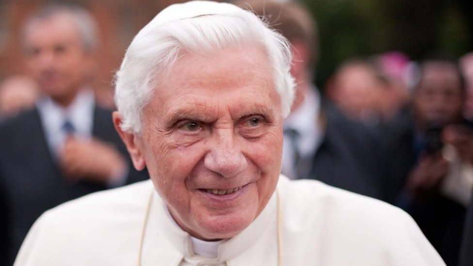 El papa emérito Benedicto XVI sonríe a un grupo en 2020